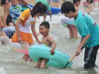 一浴实拍：数万人海边“下饺子” 萌娃抢镜